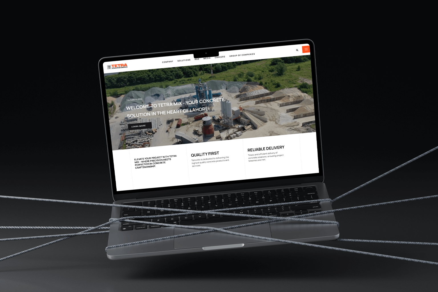 A laptop displaying the Tetra Mix website, highlighting concrete solutions with a focus on quality and reliable delivery.